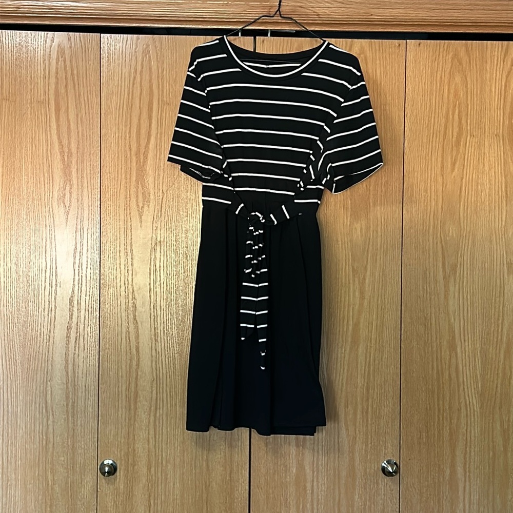 This a black and white dress with a straps that tie in the front